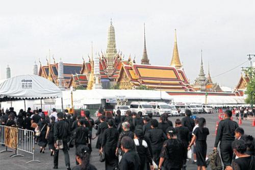 Mourners gather outside the Grand Palace