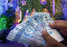 A stack of Philippine Peso bills, relating to Christmas.