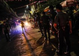 Police patrol a neighborhood in Manila